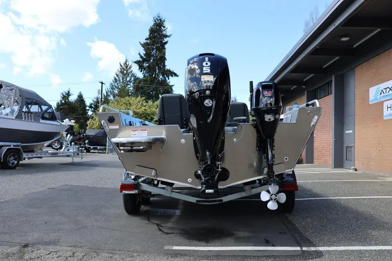Slide: The Image of 2026 Thunder Jet 209 Rush OT boat with dual outboard motors in a parking lot. - 6
