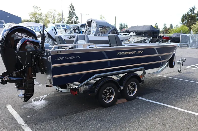 Slide: The Image of 2026 Thunder Jet 209 Rush OT boat on trailer, parked outdoors. - 7