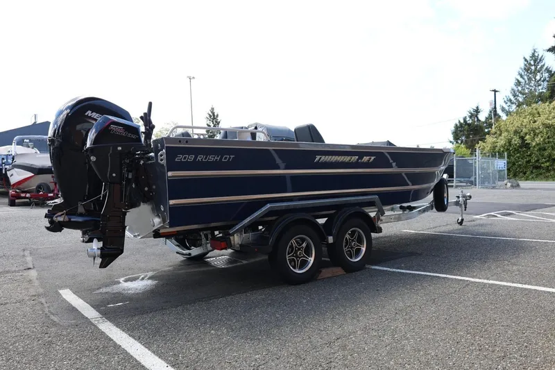 Slide: The Image of 2026 Thunder Jet 209 Rush OT boat on trailer in parking lot. - 8