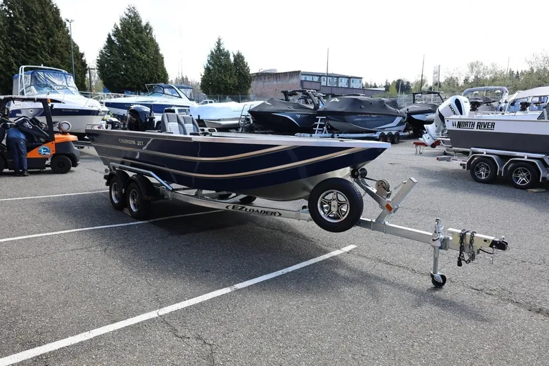 Slide: The Image of 2026 Thunder Jet 209 Rush OT boat on trailer in parking lot. - 9