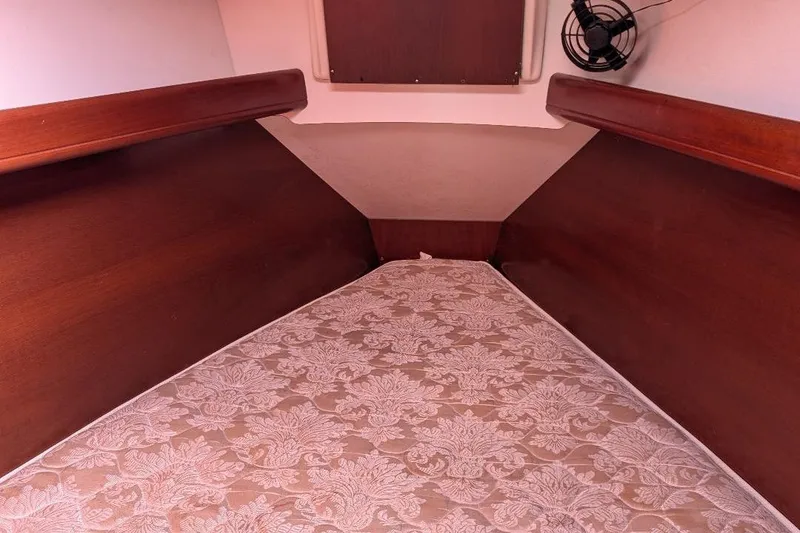 Slide: The Image of Cozy cabin interior of 2006 Beneteau 343 sailboat with floral-patterned bedding. - 13