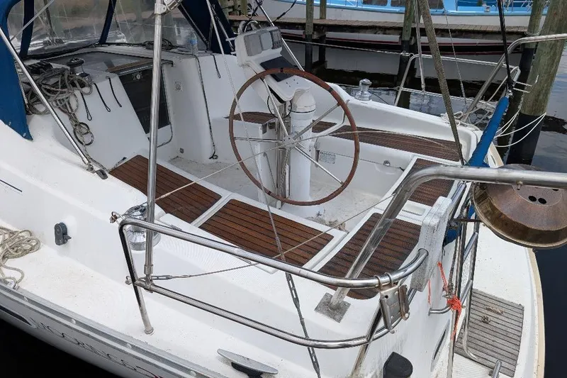 Slide: The Image of Cockpit of 2006 Beneteau Oceanis 352 sailboat with wooden deck and steering wheel. - 5