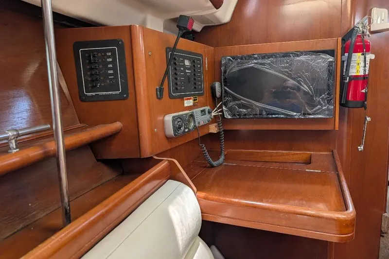 Slide: The Image of Interior of 2006 Beneteau 343 sailboat with wooden finish and cozy seating area. - 7