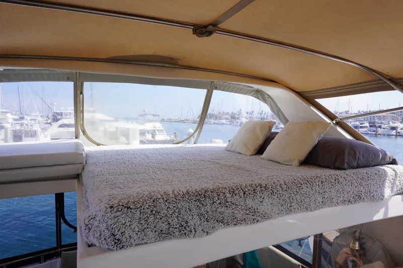 Slide: The Image of Interior of Symbol 41 Aft Cabin Yacht, cozy bed with harbor view. - 11
