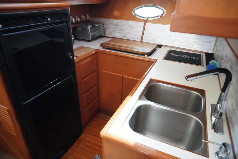 Slide: The Image of 1996 Symbol 41 Aft Cabin Yacht kitchen with double sink and refrigerator. - 28