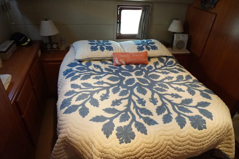 Slide: The Image of Bedroom in Symbol 41 Aft Cabin Motor Yacht, 1996, with blue bedspread. - 30