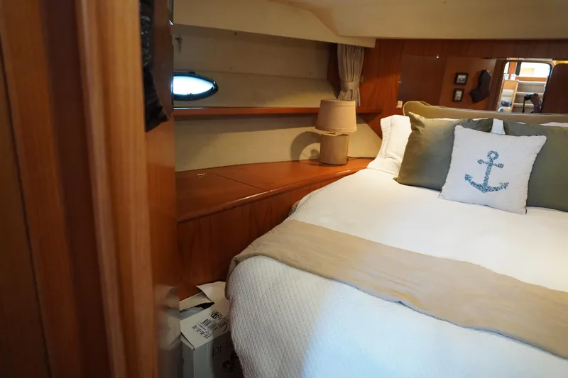 Slide: The Image of Interior of Symbol 41 Aft Cabin Yacht, cozy bedroom with nautical pillow. - 37