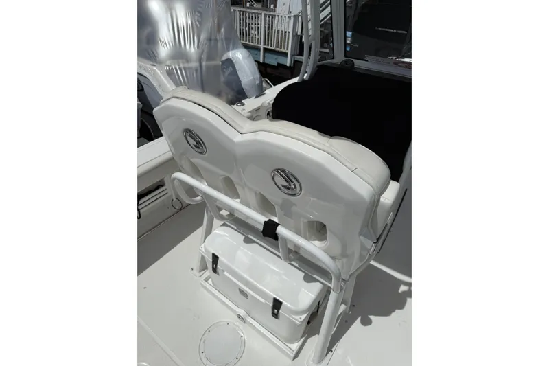 Slide: The Image of 2022 Edgewater 230CC boat seating area with storage compartment. - 16