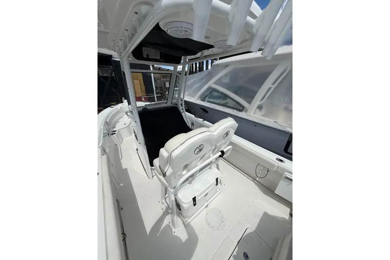 Slide: The Image of 2022 Edgewater 230CC boat interior with white seating and console, showcasing modern design. - 17