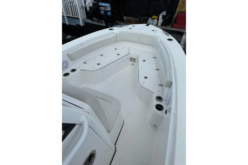 Slide: The Image of 2022 Edgewater 230CC boat interior with spacious seating and cup holders. - 21