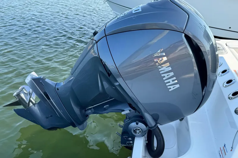 Slide: The Image of Yamaha outboard motor on 2022 Edgewater 230CC boat, floating on water. - 23