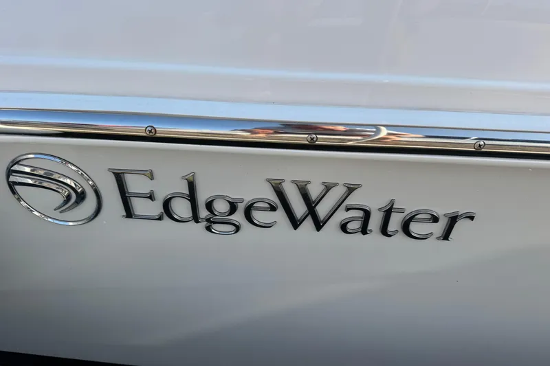 Slide: The Image of Edgewater 230CC 2022 boat logo on sleek white surface. - 25