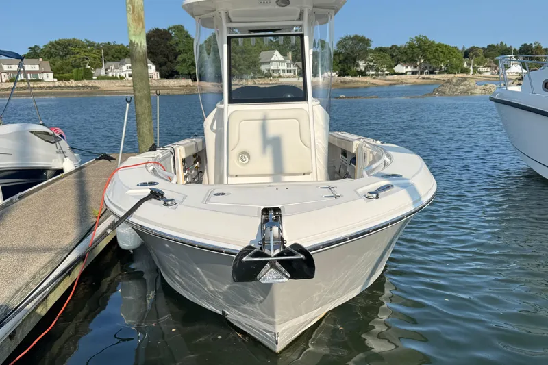 Slide: The Image of 2022 Edgewater 230CC boat docked on calm water, showcasing sleek design. - 9