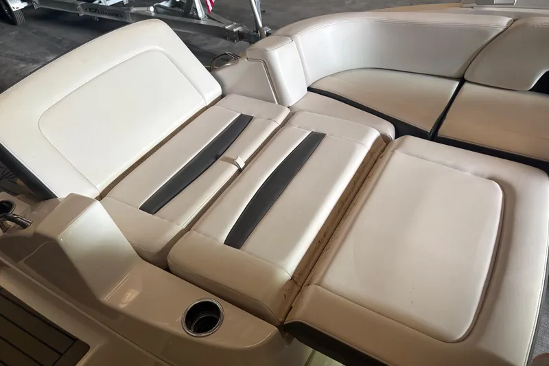 Slide: The Image of 2016 Chaparral 244 Sunesta boat interior seating with white and black upholstery. - 13