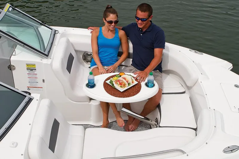 Slide: The Image of Manufacturer Provided Image: Couple enjoying a meal on a 2016 Chaparral 244 Sunesta boat. - 18