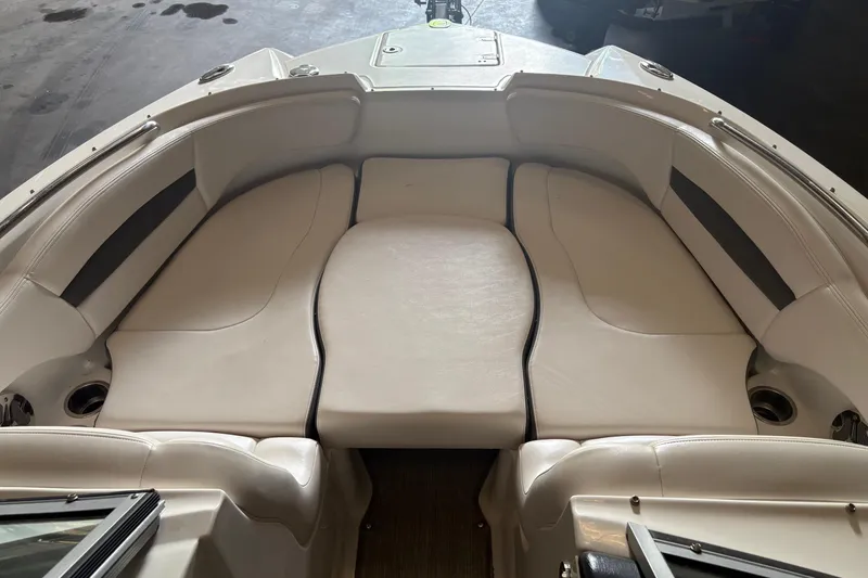 Slide: The Image of 2016 Chaparral 244 Sunesta boat interior with white cushioned seating. - 3