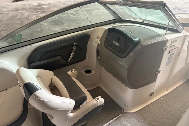 Slide: The Image of Interior of 2016 Chaparral 244 Sunesta boat, featuring seating and dashboard area. - 6