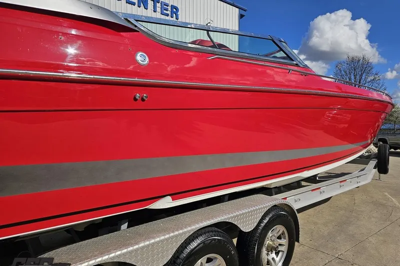 Slide: The Image of Red 1997 Formula 382 FASTech boat on trailer, parked outdoors under blue sky. - 10