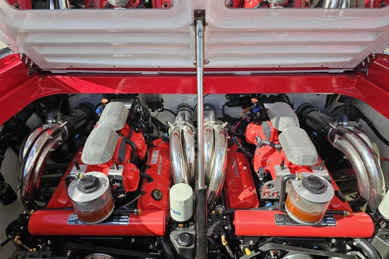 Slide: The Image of Twin engines in a 1997 Formula 382 FASTech boat, showcasing polished components and vibrant red accents. - 108