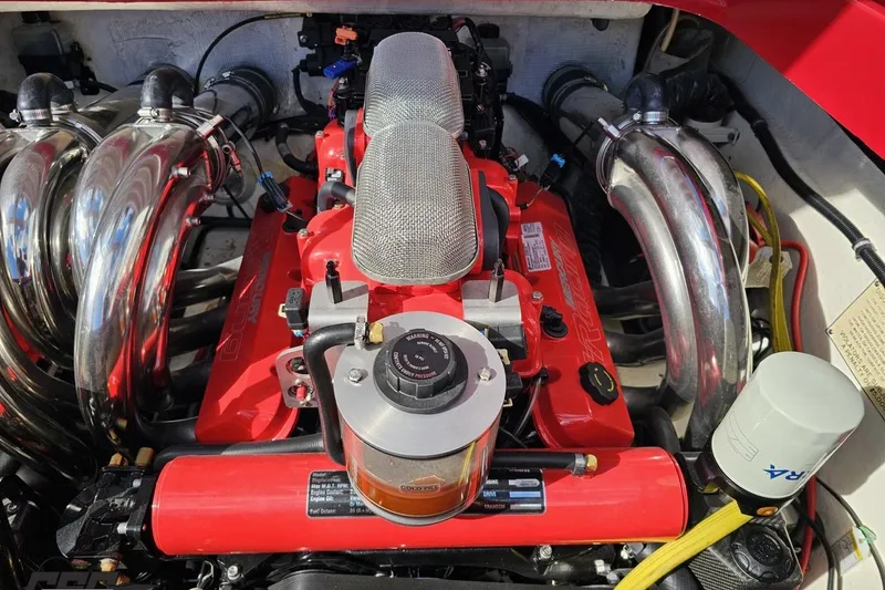 Slide: The Image of Engine of a 1997 Formula 382 FASTech boat, featuring red components and chrome exhaust headers. - 109