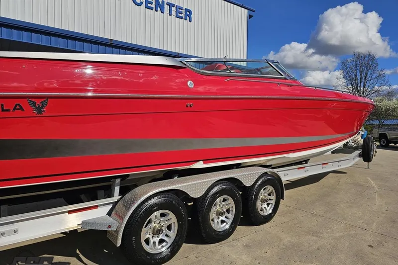 Slide: The Image of Red 1997 Formula 382 FASTech boat on trailer, parked outdoors under blue sky. - 11