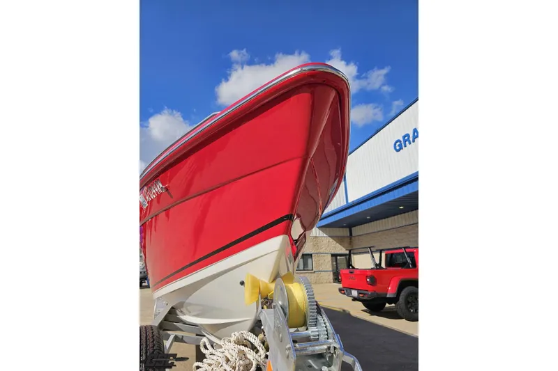 Slide: The Image of Red 1997 Formula 382 FASTech boat on trailer, parked outside a building under blue sky. - 15