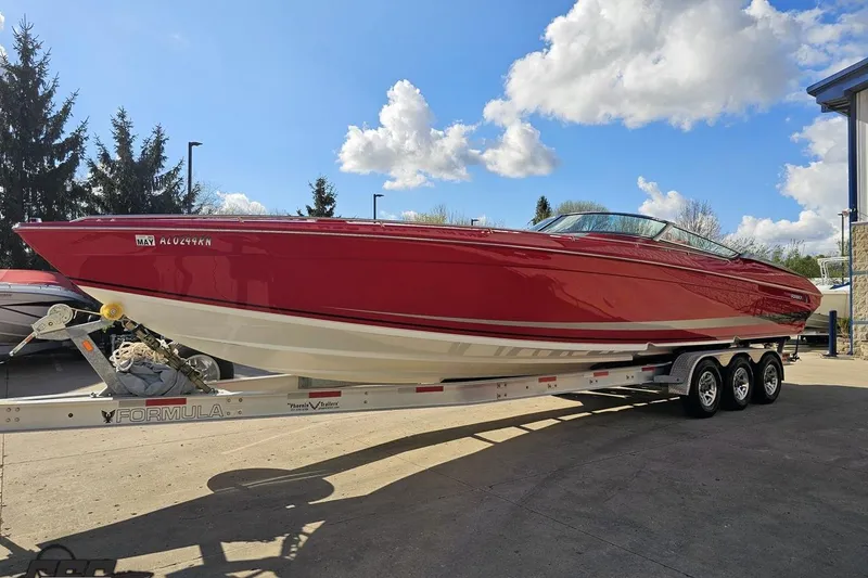 Slide: The Image of Red 1997 Formula 382 FASTech boat on trailer under blue sky. - 16