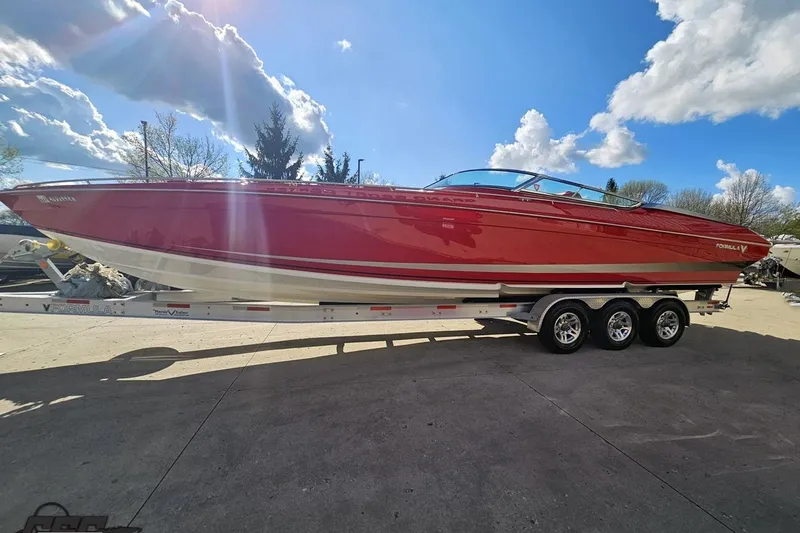 Slide: The Image of Red 1997 Formula 382 FASTech boat on a trailer under a bright blue sky. - 17
