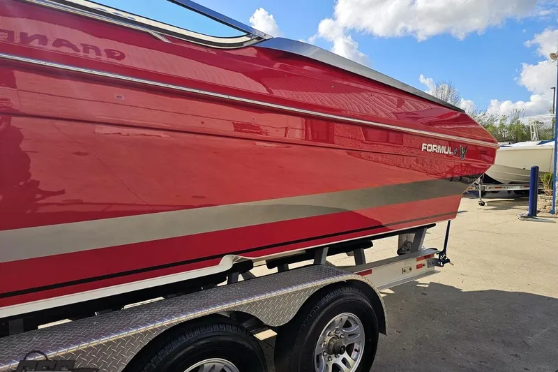 Slide: The Image of Red 1997 Formula 382 FASTech boat on trailer under blue sky. - 20