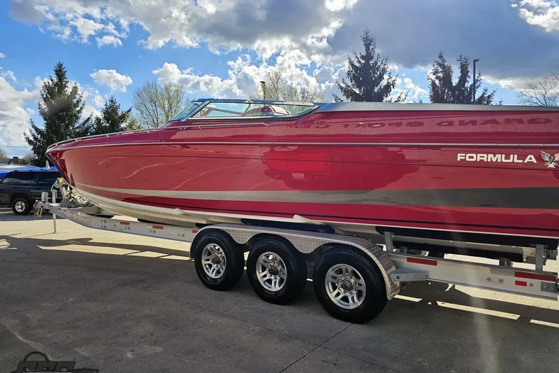 Slide: The Image of Red 1997 Formula 382 FASTech boat on trailer under a partly cloudy sky. - 24