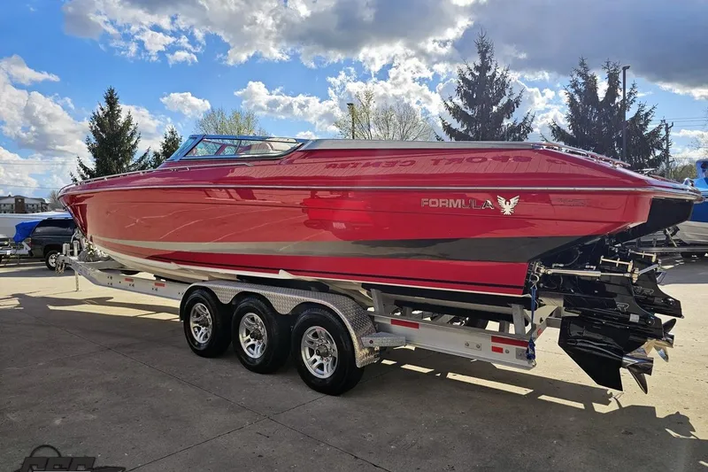 Slide: The Image of Red 1997 Formula 382 FASTech boat on a trailer under a partly cloudy sky. - 25