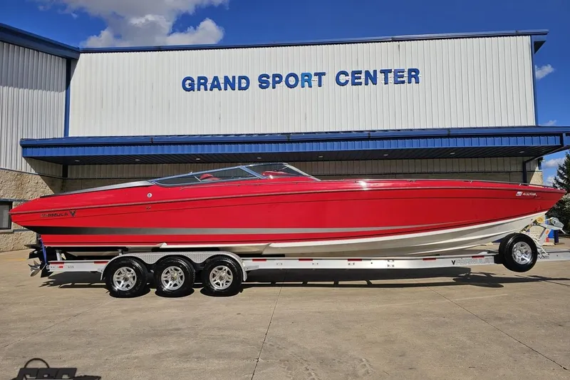 Slide: The Image of Red 1997 Formula 382 FASTech boat on trailer at Grand Sport Center. - 3