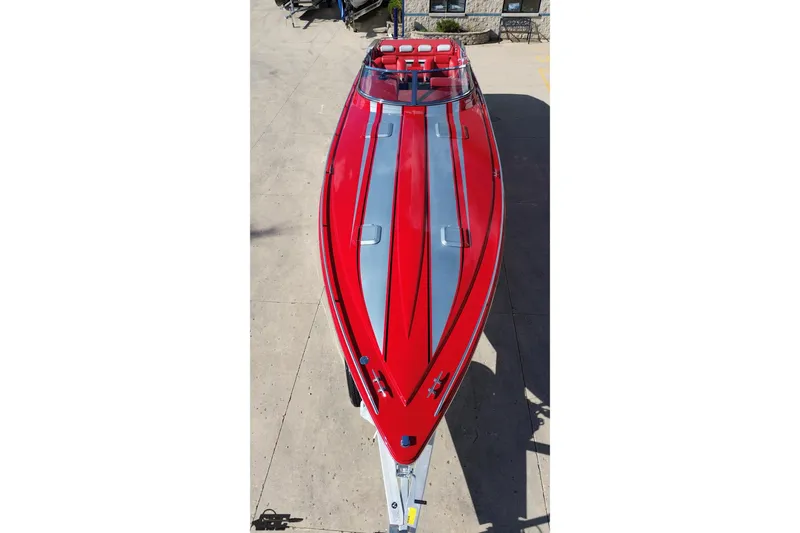 Slide: The Image of Red 1997 Formula 382 FASTech speedboat, aerial view, sleek design, parked on concrete surface. - 38