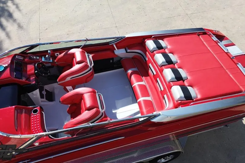 Slide: The Image of Red and white interior of a 1997 Formula 382 FASTech speedboat, featuring sleek seating and controls. - 44