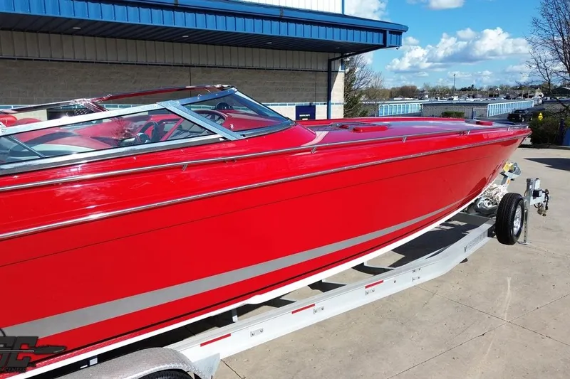 Slide: The Image of Red 1997 Formula 382 FASTech boat on trailer, parked outdoors under blue sky. - 45