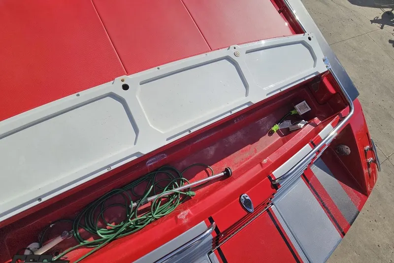 Slide: The Image of Red and white 1997 Formula 382 FASTech boat with open storage compartment. - 50