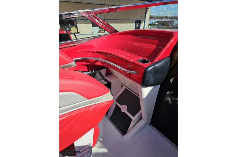 Slide: The Image of Red interior of a 1997 Formula 382 FASTech boat, featuring sleek design and cup holder. - 59