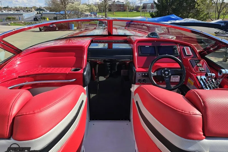 Slide: The Image of Red interior of a 1997 Formula 382 FASTech boat, featuring a sleek dashboard and steering wheel. - 61