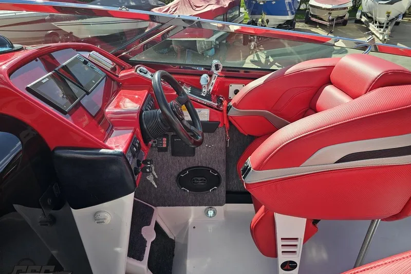 Slide: The Image of Interior of a 1997 Formula 382 FASTech boat with red seating and dashboard. - 62