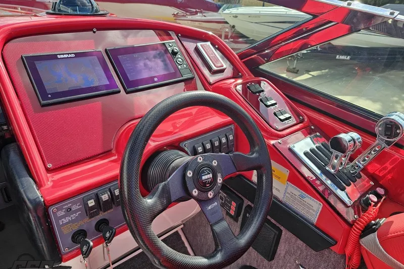 Slide: The Image of Red dashboard of a 1997 Formula 382 FASTech boat with steering wheel and controls. - 63