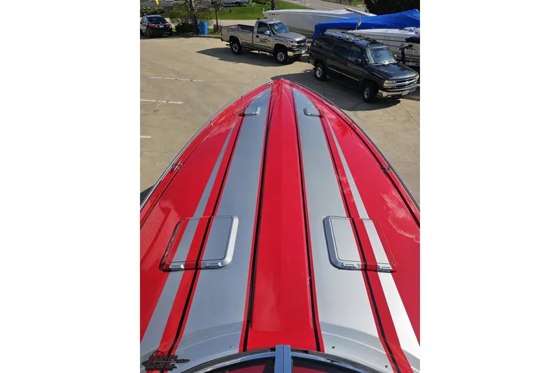 Slide: The Image of Red and silver 1997 Formula 382 FASTech boat with sleek design in a parking area. - 68