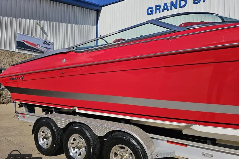 Slide: The Image of Red 1997 Formula 382 FASTech boat on trailer outside Grand Sport Center. - 7