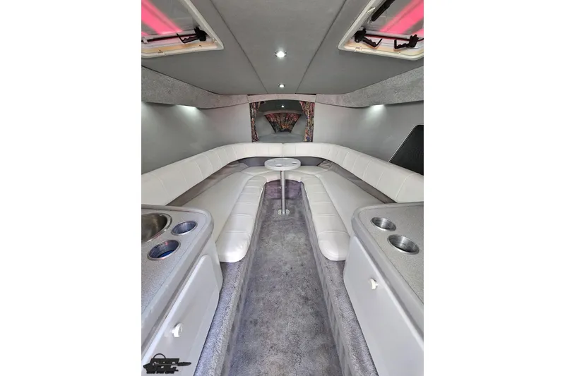 Slide: The Image of Interior of a 1997 Formula 382 FASTech boat with white seating and modern amenities. - 70