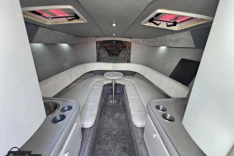 Slide: The Image of Interior of a 1997 Formula 382 FASTech boat with white seating and modern amenities. - 71