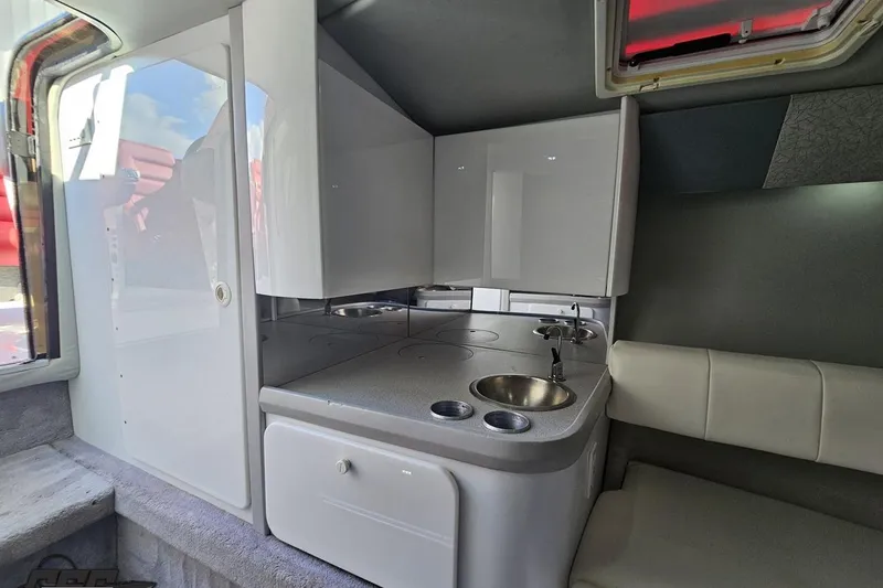 Slide: The Image of Interior of a 1997 Formula 382 FASTech boat with kitchenette and seating area. - 75