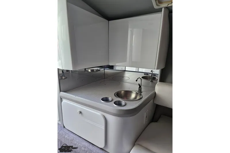 Slide: The Image of Interior kitchenette of a 1997 Formula 382 FASTech boat with sink and storage. - 76
