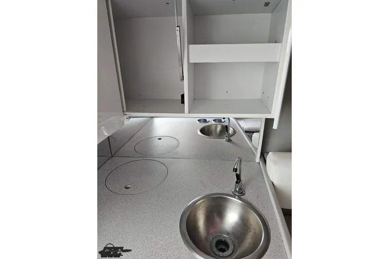 Slide: The Image of 1997 Formula 382 FASTech boat interior with sink and storage cabinets. - 77