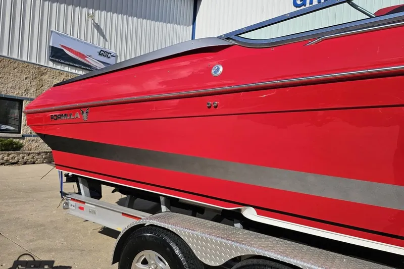 Slide: The Image of Red 1997 Formula 382 FASTech boat on trailer, parked outside a building. - 8