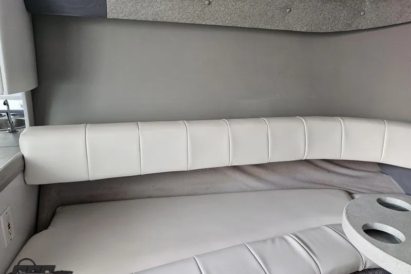Slide: The Image of Interior of a 1997 Formula 382 FASTech boat with white cushioned seating. - 80