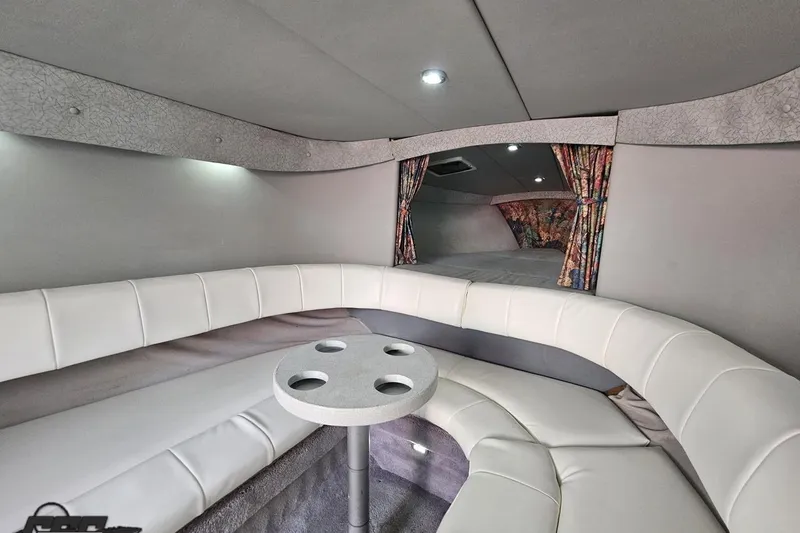 Slide: The Image of Interior of a 1997 Formula 382 FASTech boat with white seating and a small table. - 81
